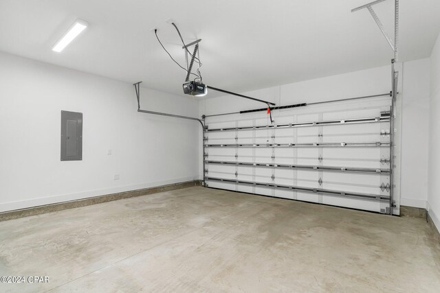 garage with a garage door opener and electric panel