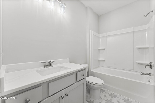 full bathroom with vanity, washtub / shower combination, and toilet