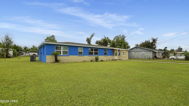 view of front of house with central AC unit and a front lawn