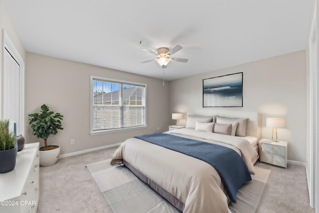 carpeted bedroom featuring ceiling fan and a closet