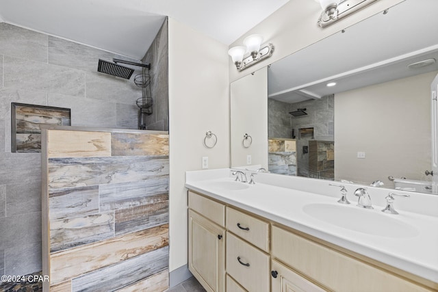 bathroom with tile walls, vanity, and tiled shower