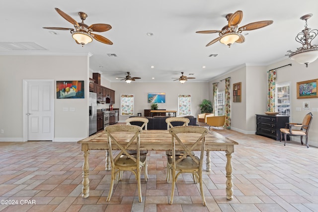 dining space with ornamental molding and ceiling fan