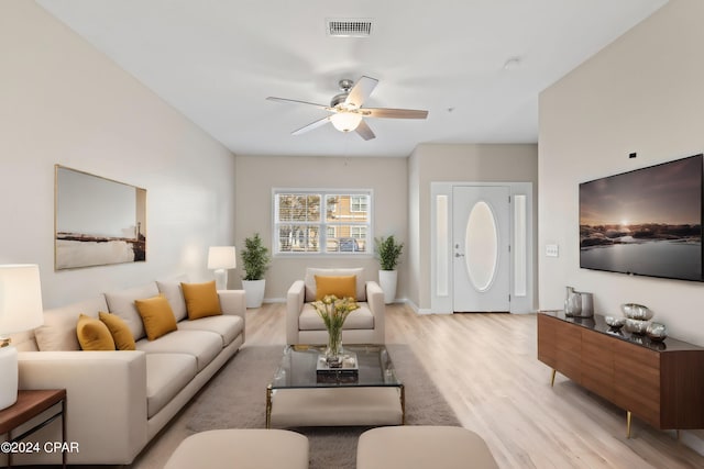 living room featuring ceiling fan and light hardwood / wood-style flooring