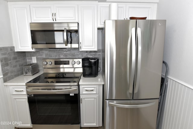 kitchen with white cabinetry, tasteful backsplash, and appliances with stainless steel finishes