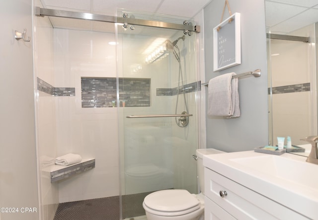 bathroom featuring a shower stall, toilet, and vanity