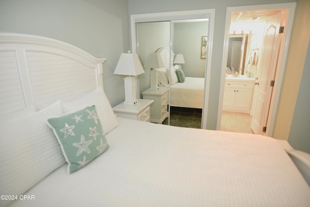 bedroom featuring ensuite bath and a closet