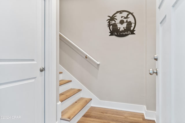 staircase with hardwood / wood-style floors