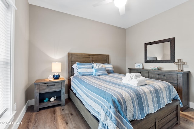 bedroom with ceiling fan and hardwood / wood-style flooring