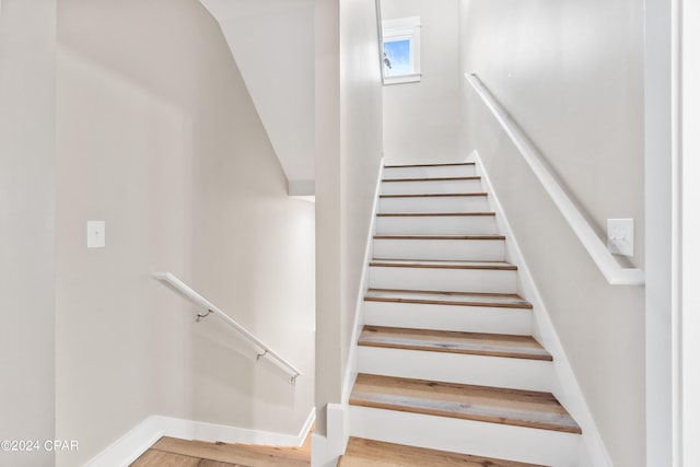 staircase featuring hardwood / wood-style flooring