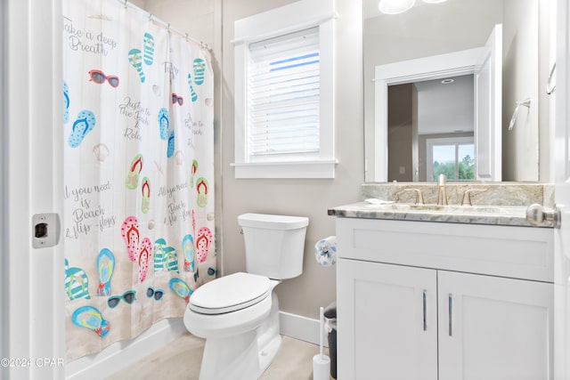 bathroom featuring tile patterned floors, curtained shower, vanity, and toilet