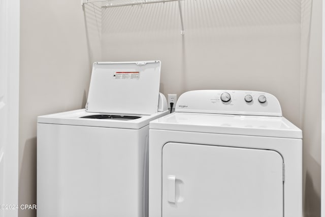 clothes washing area featuring separate washer and dryer