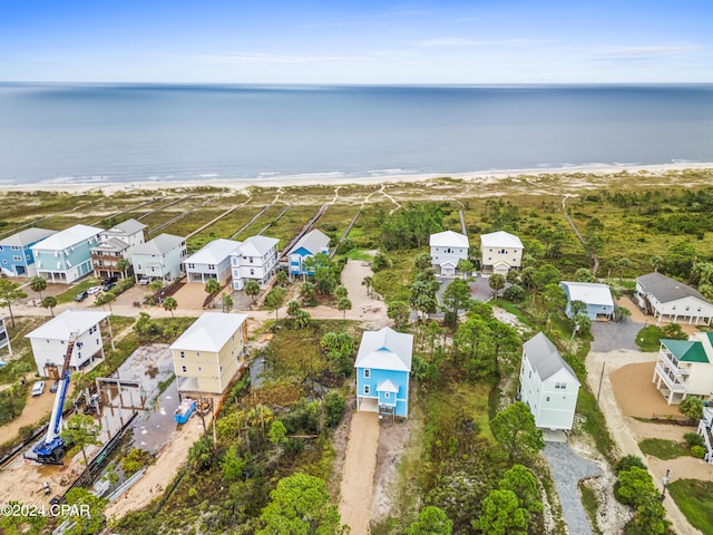 drone / aerial view featuring a beach view and a water view