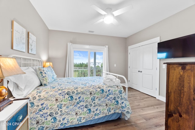 bedroom featuring a closet, light wood-type flooring, ceiling fan, and access to exterior