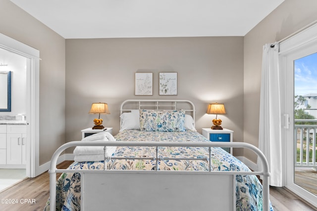 bedroom with light hardwood / wood-style floors and ensuite bathroom