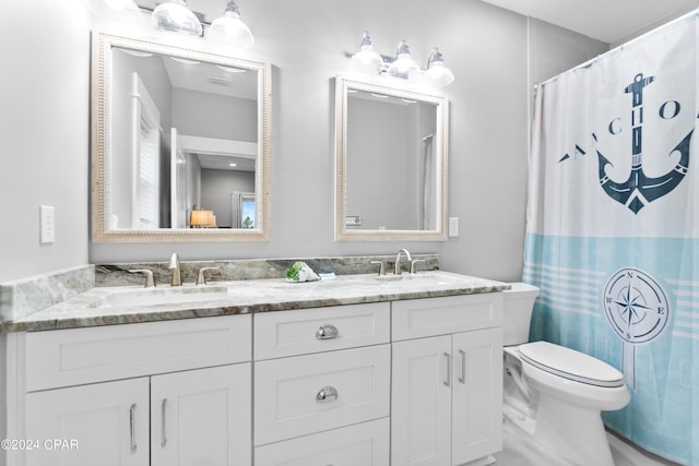 bathroom featuring vanity, toilet, and a shower with curtain