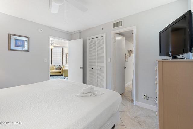 tiled bedroom featuring a closet and ceiling fan