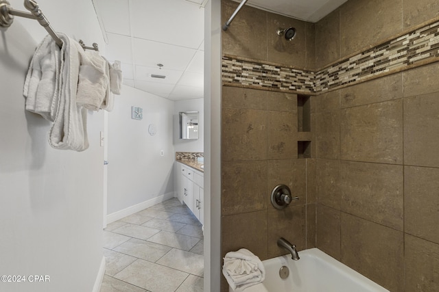 bathroom featuring tile patterned floors, tiled shower / bath combo, and vanity