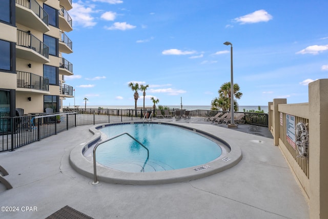 view of pool with a water view