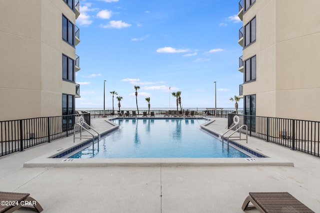 view of pool featuring central AC unit and a patio area