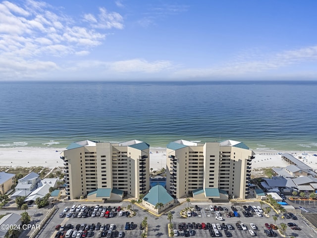 drone / aerial view with a beach view and a water view