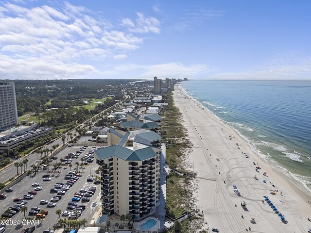 drone / aerial view featuring a water view and a view of the beach