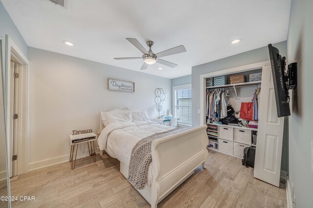 bedroom with light hardwood / wood-style flooring, a closet, and ceiling fan