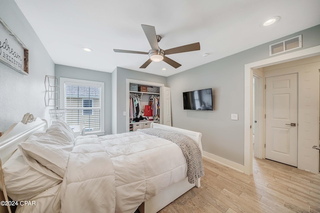 bedroom with ceiling fan, a closet, and light wood-type flooring