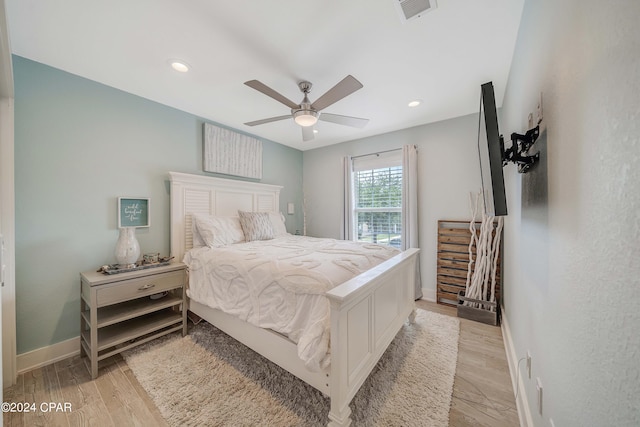 bedroom with ceiling fan and light hardwood / wood-style floors