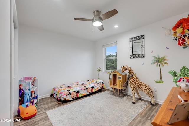 bedroom with ceiling fan and wood-type flooring