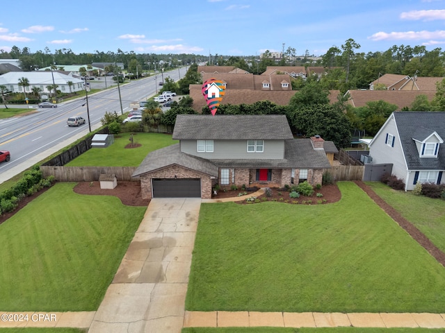 view of front of house featuring a garage and a front yard