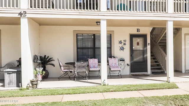 view of exterior entry featuring a balcony