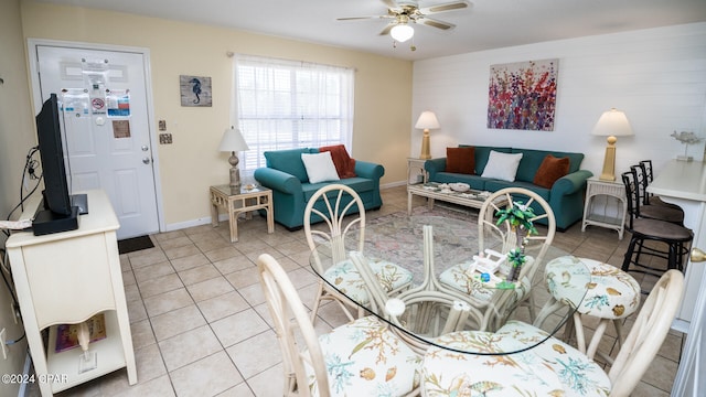 living room with ceiling fan and tile patterned flooring