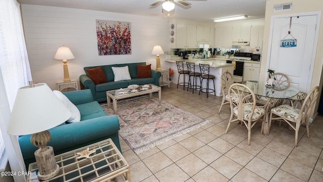 living room with light tile patterned floors and ceiling fan