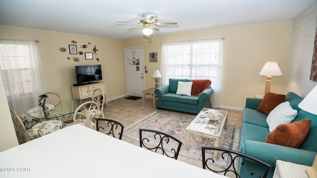 tiled living room with ceiling fan