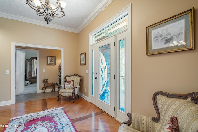 entrance foyer featuring wood finished floors, a healthy amount of sunlight, and ornamental molding