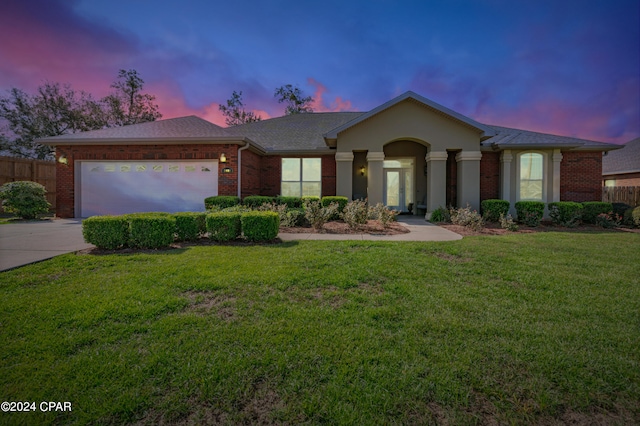 ranch-style house with brick siding, fence, concrete driveway, a yard, and an attached garage