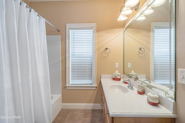 full bathroom featuring vanity, shower / bathtub combination with curtain, baseboards, and tile patterned flooring