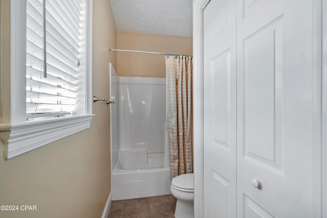 bathroom with a textured ceiling, shower / bath combination with curtain, tile patterned flooring, and toilet