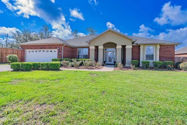 ranch-style home with brick siding, an attached garage, a front lawn, and fence