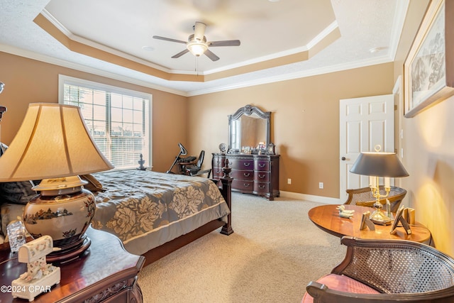 carpeted bedroom with baseboards, a raised ceiling, ceiling fan, and crown molding