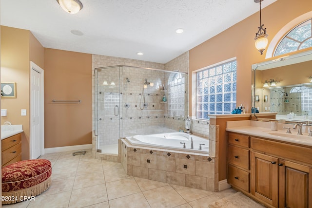 bathroom featuring a wealth of natural light, tile patterned flooring, a shower stall, and vanity