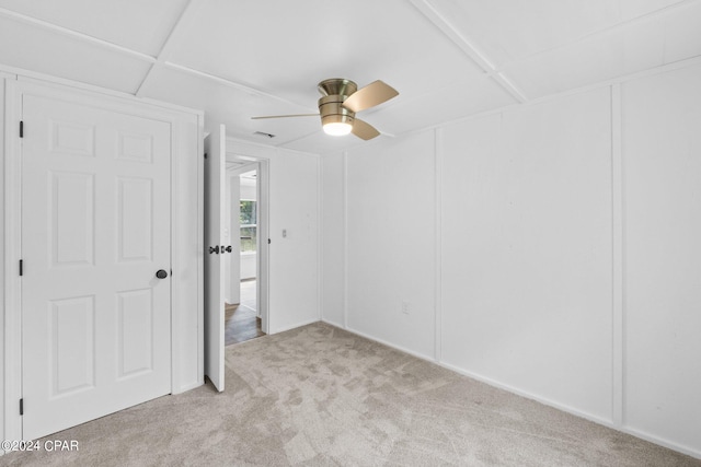 unfurnished bedroom featuring light carpet and ceiling fan