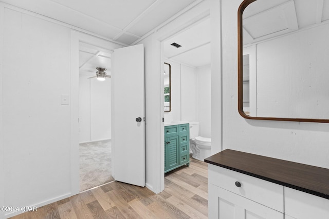 bathroom with ceiling fan, vanity, hardwood / wood-style floors, and toilet