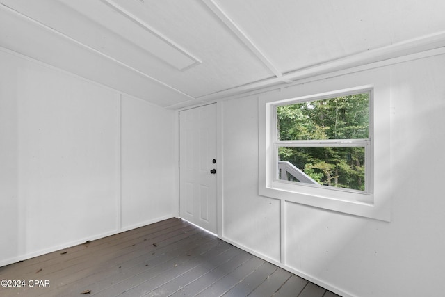 spare room featuring dark wood-type flooring