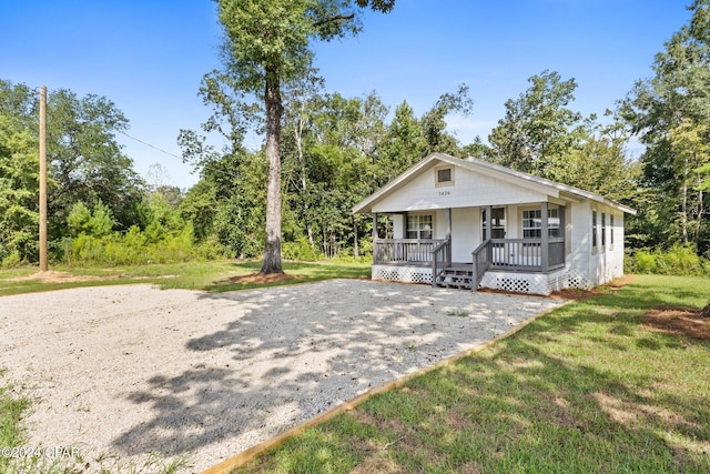 view of front of house with a porch and a front yard