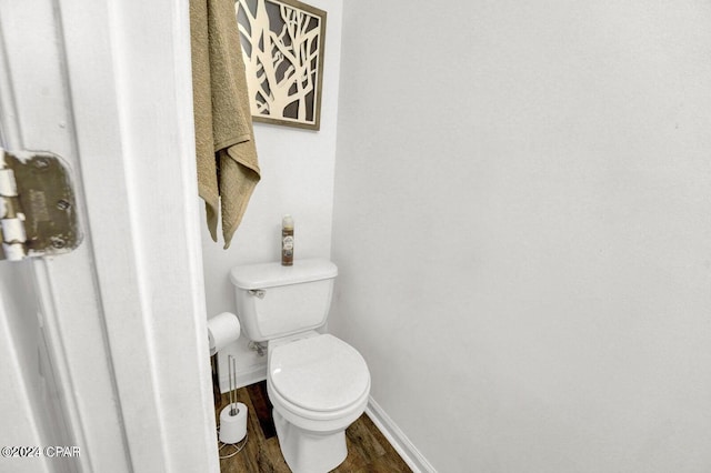 bathroom featuring hardwood / wood-style flooring and toilet