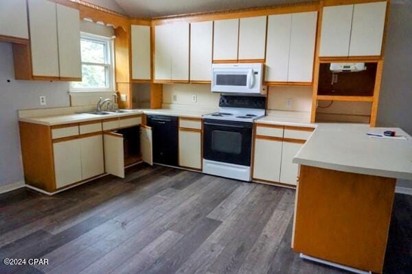 kitchen featuring white appliances, dark wood-type flooring, and white cabinets