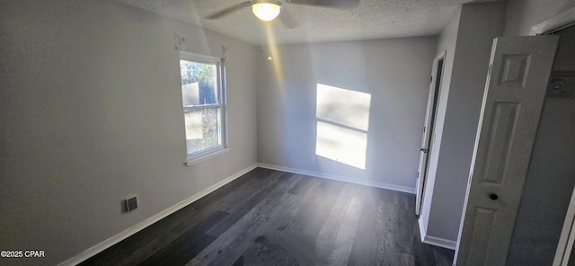 spare room featuring ceiling fan, dark hardwood / wood-style flooring, and a textured ceiling