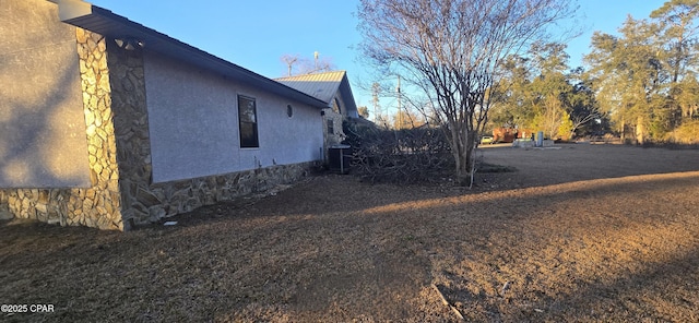 view of property exterior with central AC unit