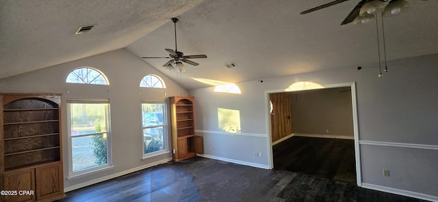 unfurnished room featuring ceiling fan, dark hardwood / wood-style flooring, vaulted ceiling, and a textured ceiling